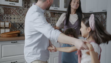 family dancing in the kitchen