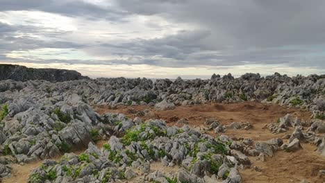 rocky coastal cliffs with blowholes in asturias under a moody cloudy sky