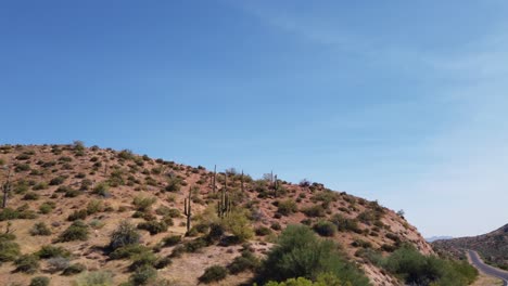 a deserted highway snakes through the sonoran desert, scottsdale, arizona.