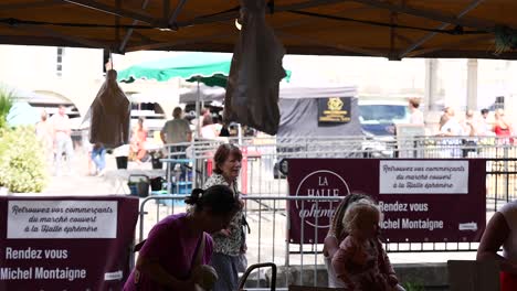 people interacting at a market stall