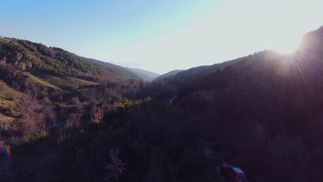 Areal-footage-of-off-road-rally-car-driving-on-foothills-at-high-speed