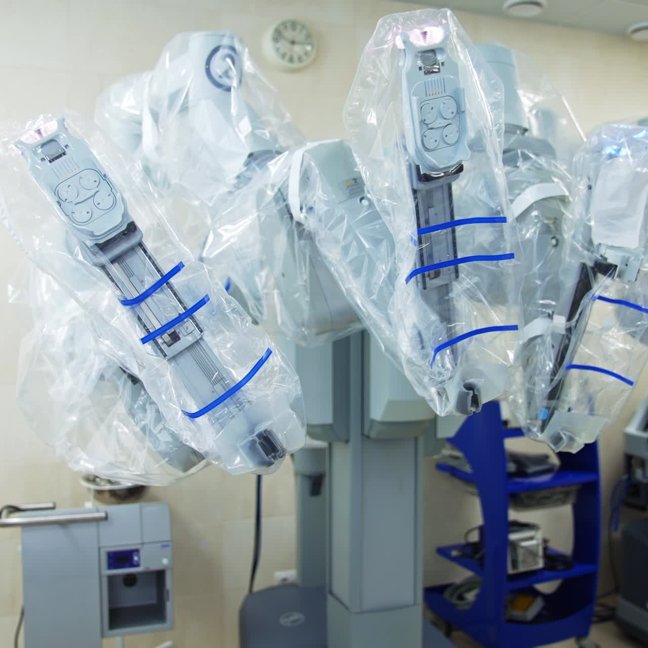 Modern surgery theatre in hospital with high-precise advanced equipment. Da Vinci robot covered in plastic in the middle of the room