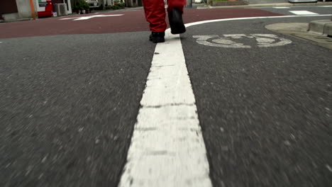 following behind a man walking down the street