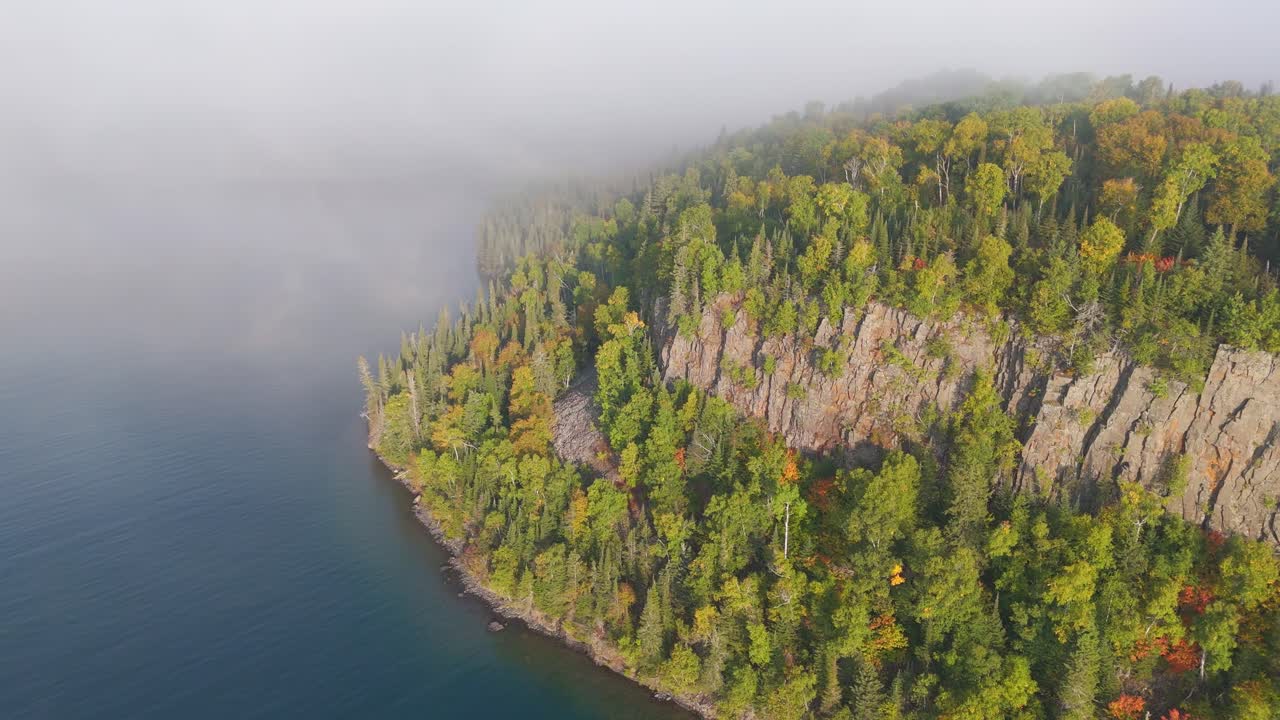 Vertical cliff and forest during early autumn at Lake Superior shoreline in Ontario, Canada