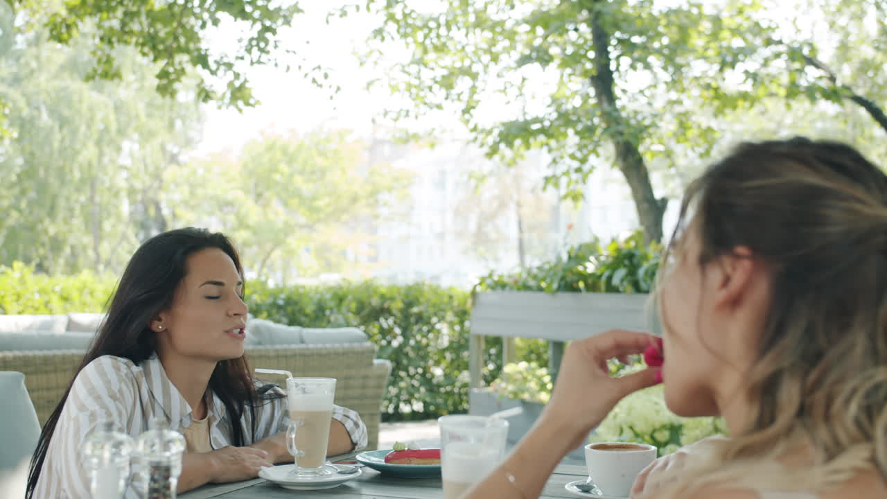 Friends enjoying a meal and drinks outdoors