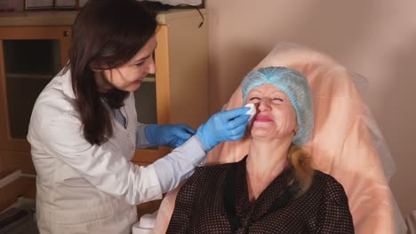 woman receiving a facial treatment from a doctor.