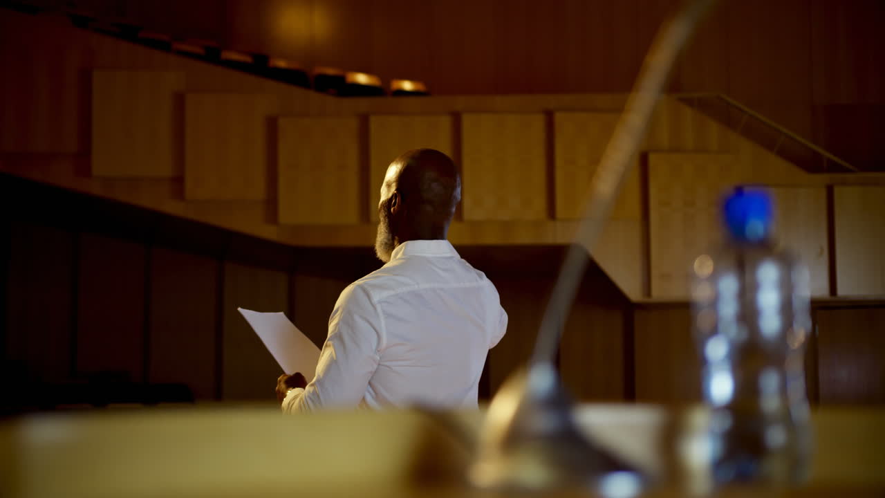 Senior African American businessman practicing speech in empty auditorium 4k