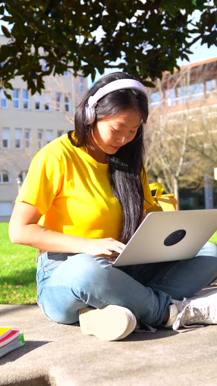 Studente universitario che si gode la musica mentre studia nel campus