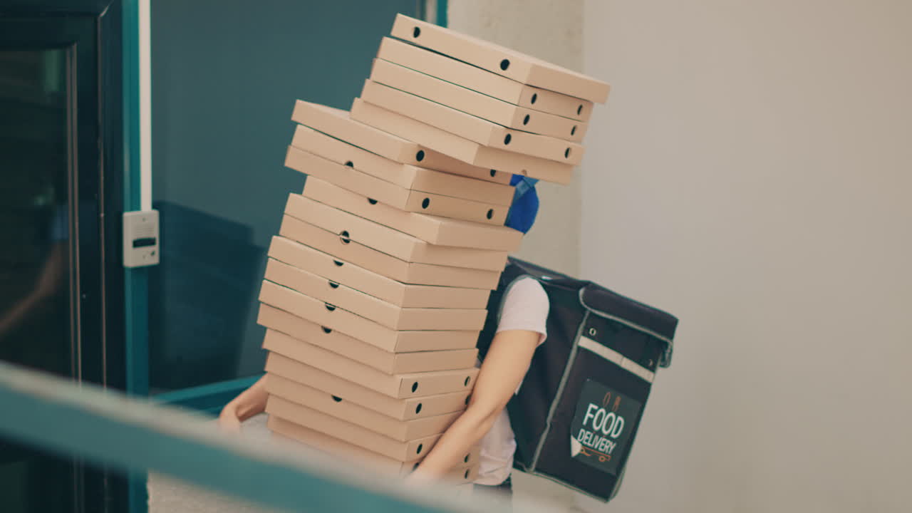 Pizza delivery with a large stack of pizza boxes