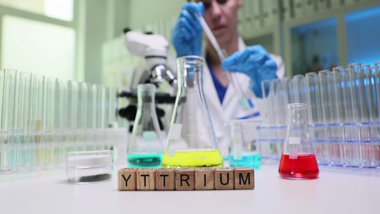 Lab worker transfers liquid sample into test tube using pipette