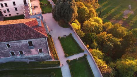 Luftaufnahme-Einer-Mittelalterlichen-Burg-Auf-Einem-Hügel,-Umgeben-Von-Weinbergen,-In-Italien,-Bei-Sonnenaufgang