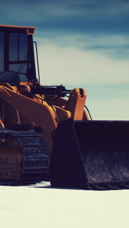 orange bulldozer in snow