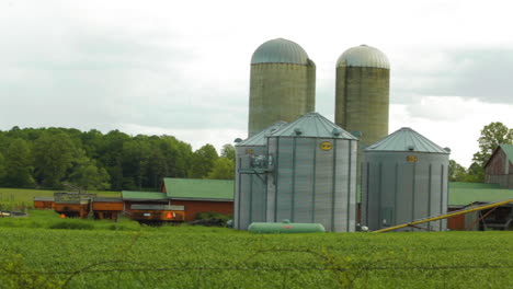 rustic farm with a red barn and grain silos