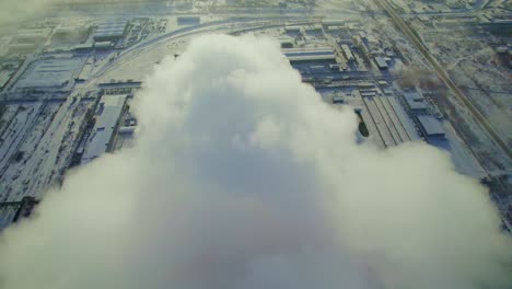 industrial plant in winter with steam emission