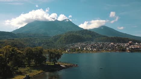 drone aerial landscape view of volcanoes, mountains and lake atitlan, guatemala during a sunny day