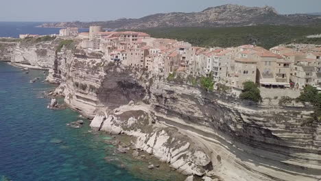 Aerial-footage-moving-in-from-seaside-on-buildings-of-Bonifacio