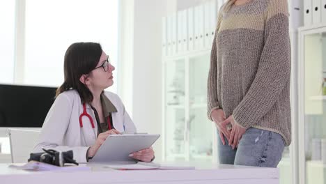 female patient consulting doctor in medical office