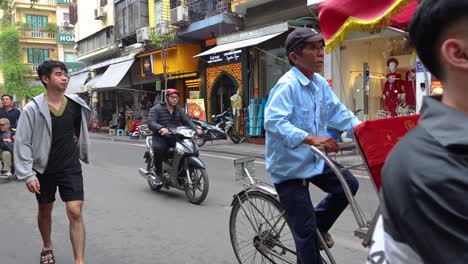 pedestrians and vehicles moving on busy city road