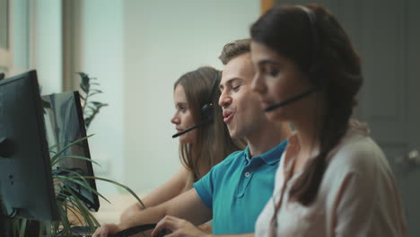 smiling call center worker talking with clients. happy man finishing discussion