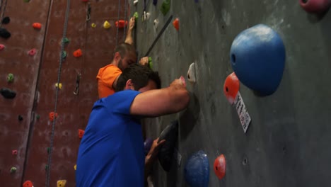 men and woman climbing the artificial wall 4k