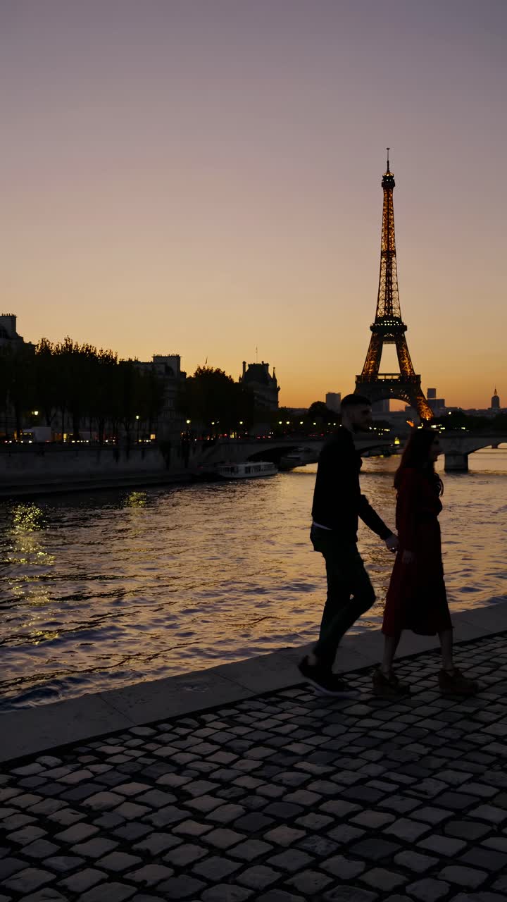 Romantic sunset video shot in Paris with a low-angle view of the Eiffel Tower, capturing a couple
