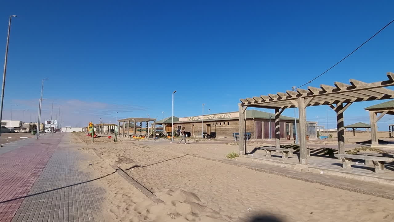 Girl with long hair walks on a lonely street in Casa del mar, Tarfaya,, Marroco. 4K videos