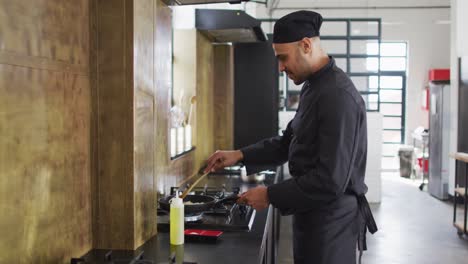 caucasian male chef frying vegetables on a pan