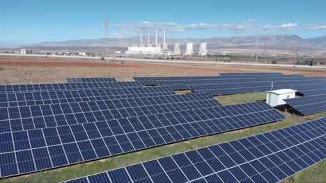 drone photovoltaic solar panel park with coal fired power station in background