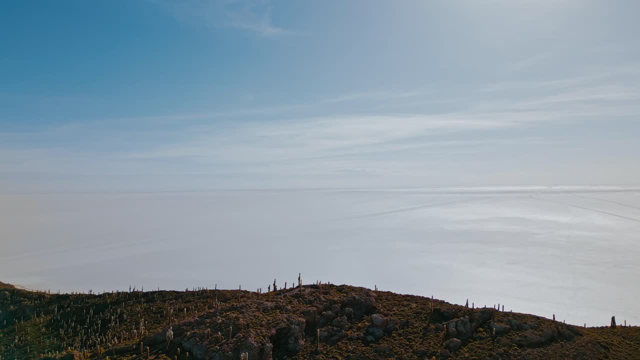 Experience Bolivia's majestic allure at sunrise with stunning drone footage of Isla Incahuasi, Salar de Uyuni's endless salt flats, and striking cacti from above