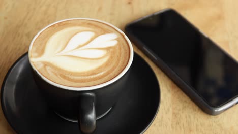 A-cup-of-late-coffee-with-flower-shape-design-on-top-at-cafe