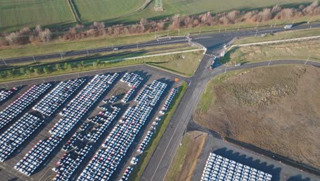 high aerial view of vast mass storage parking lot near highway