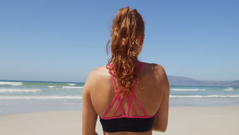 woman exercising at beach on a sunny day 4k