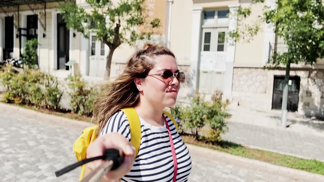 Curious Traveler Woman Looking Up at City Buildings, Athens, Greece