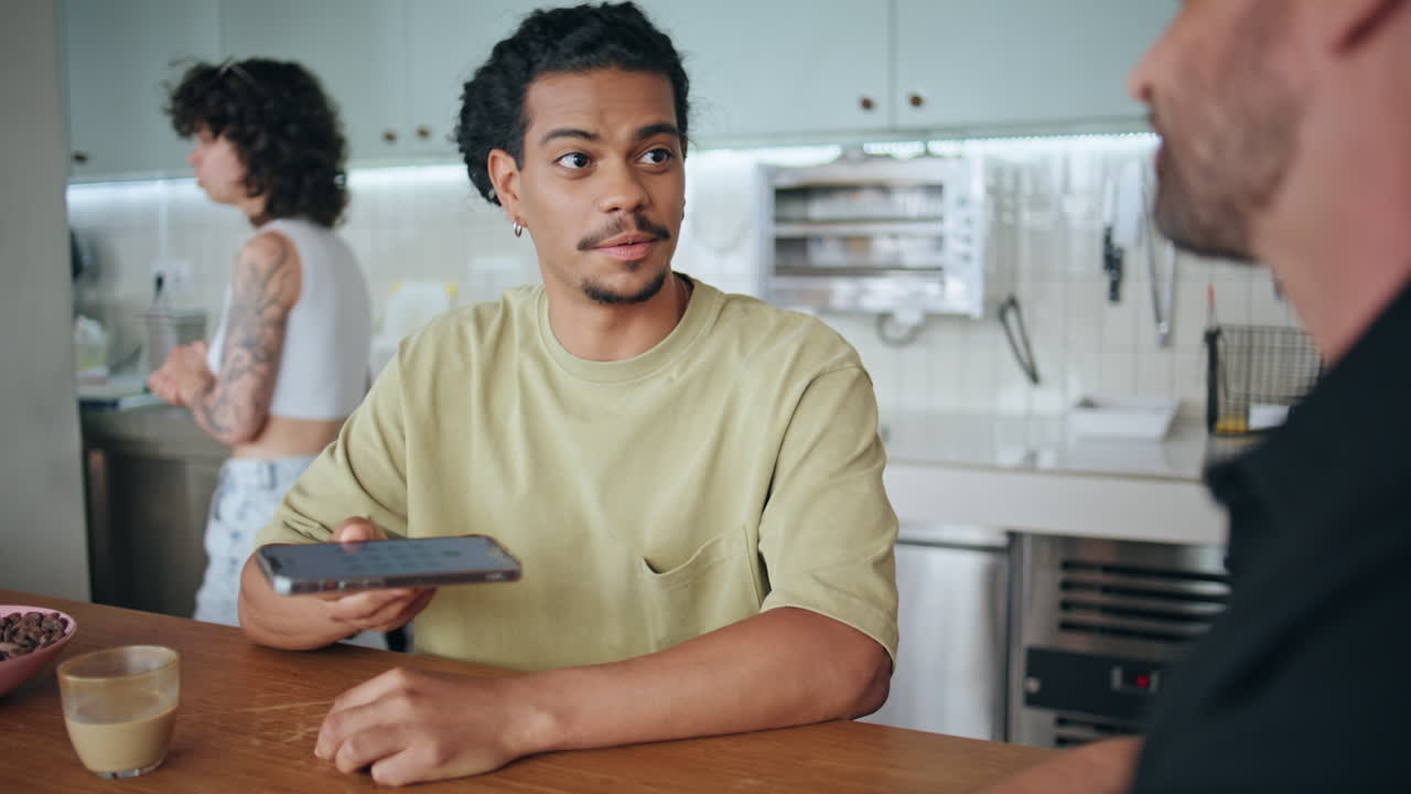 Men exchange phone numbers after acquaintance in cafeteria closeup. Meeting cafe