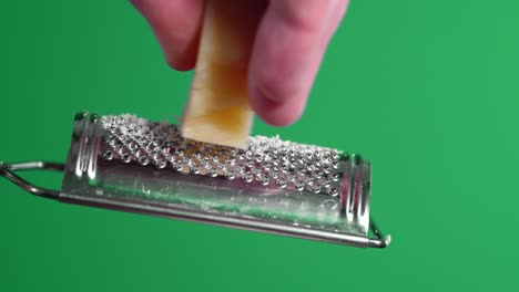 male hands grated cheese on a grater.