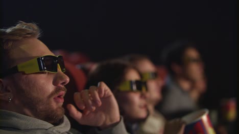 Man-take-off-movie-glasses-in-cinema-in-slow-motion.-Tired-from-3d-movie
