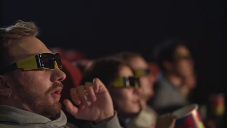 man take off movie glasses in cinema in slow motion. tired from 3d movie