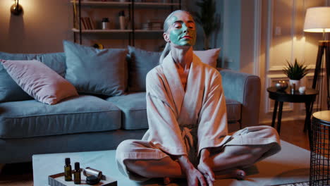 woman relaxing at home with a face mask for a self-care routine