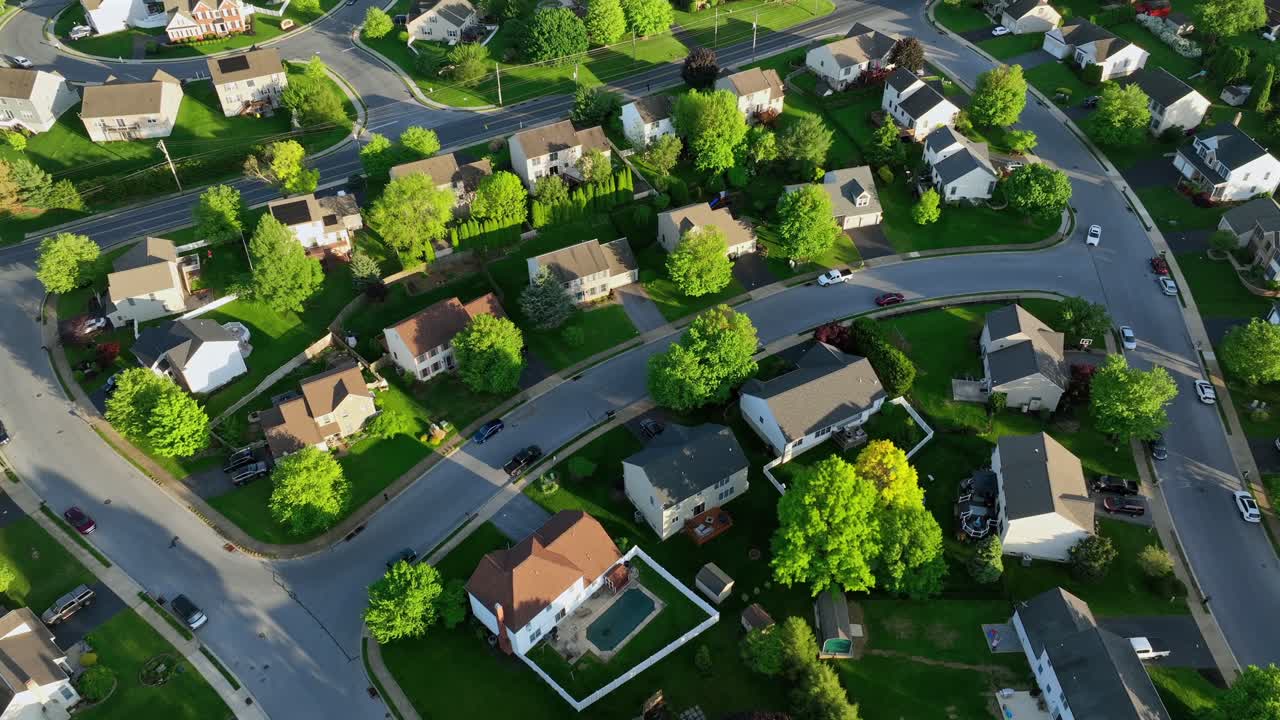 Modern Single family houses and homes in upper class district of american town. Sunny spring day with green trees. Quiet and serene atmosphere in Pennsylvania, United States. Drone top down shot.