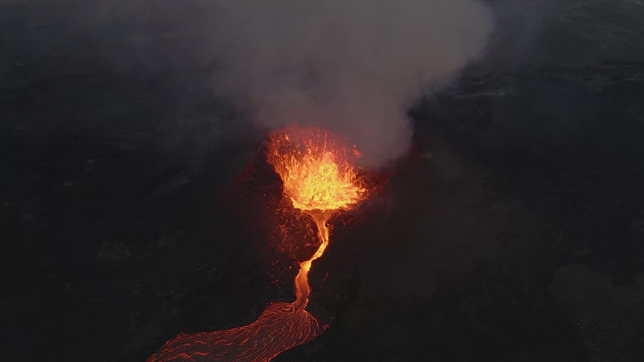 Magma spurts from crater fissure of erupting volcano, Iceland