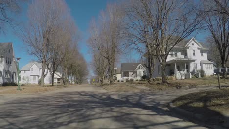 driving on street in neighborhood od small american midwest town, driver pov