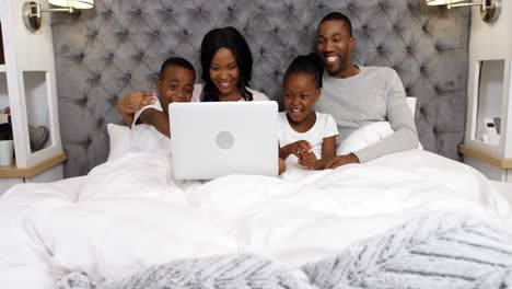 Family-using-laptop-in-bedroom-4k