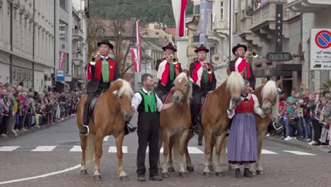 traditional horse parade with trumpet band in european town