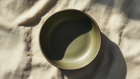 green bowl on a cloth background