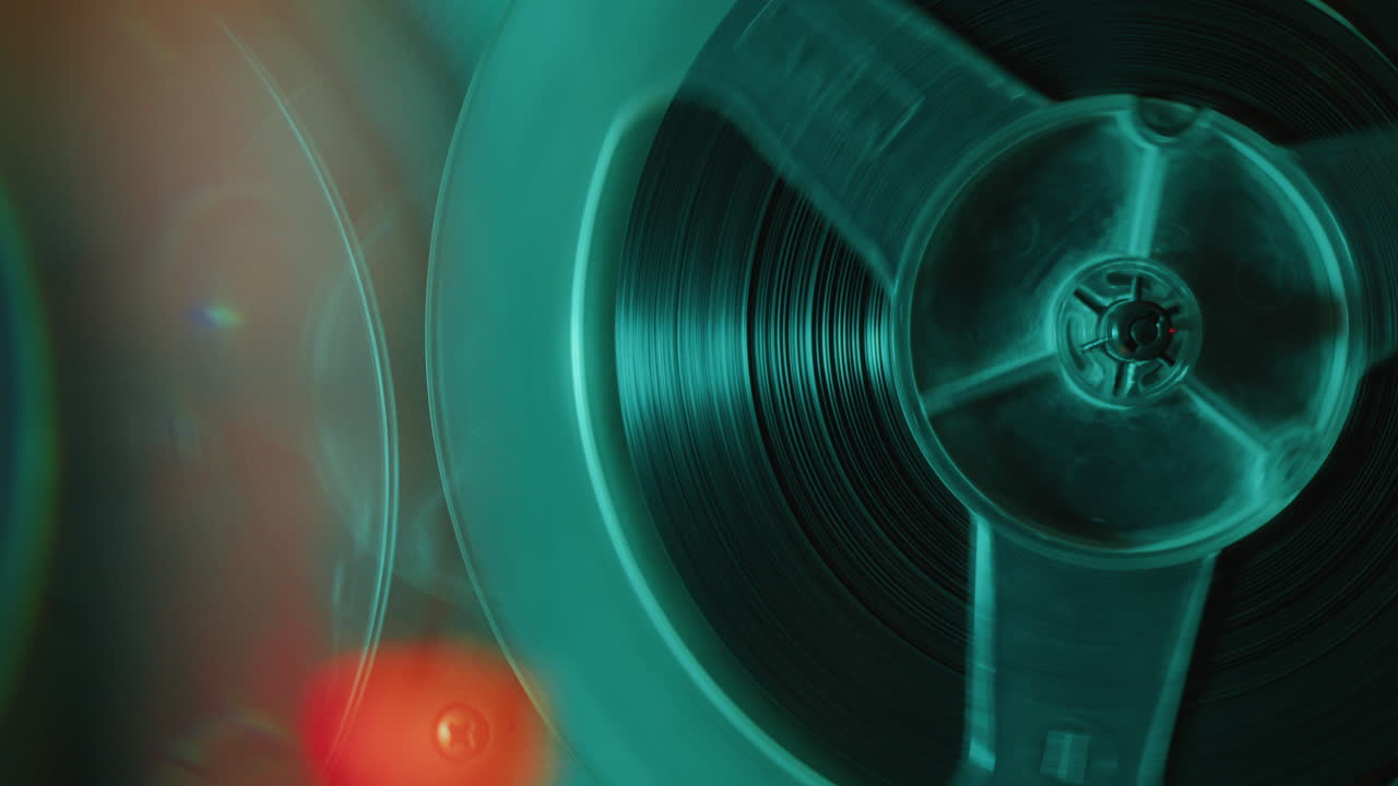 Macro of Rotating Spool of Retro Reel-To-Reel Tape Player in Operation