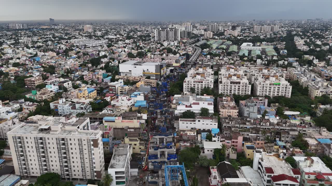 Aerial video of Chennai's urban growth. Features include modern high-rises, sprawling residential areas, and active construction sites, with themes on real estate development and city expansion