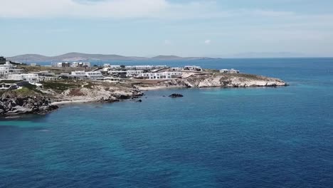 aerial drone moving forward on blue beach mykonos