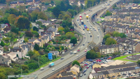 wide angle timelapse of cars and trucks moving fast along motorway dual carriageway with congested traffic with motion blur. urban city transport example in port talbot, wales uk 4k