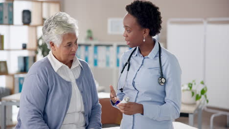 doctor consulting with elderly patient in clinic