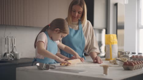 homemade bakery, woman and child are cooking together in kitchen, girl is rolling out dough